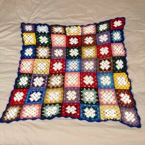 Crochet afghan - blue border with multicolored granny core squares
